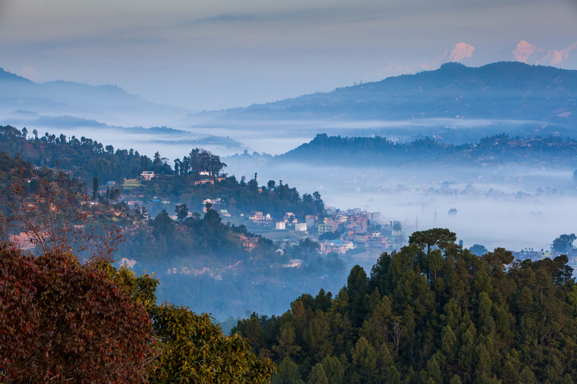 Aerial shot of a Nepalese village with morning mist