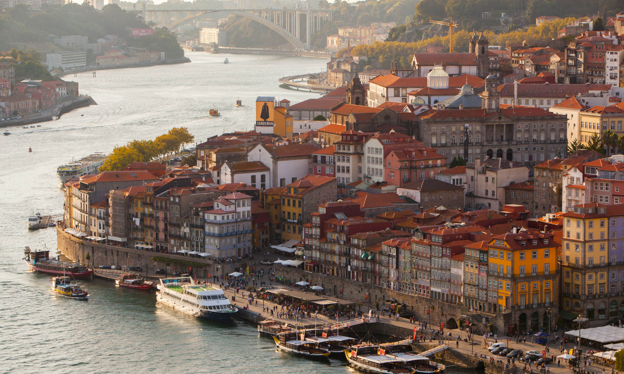 View of the Douro River and historic district of Porto, Portugal with boats along the river