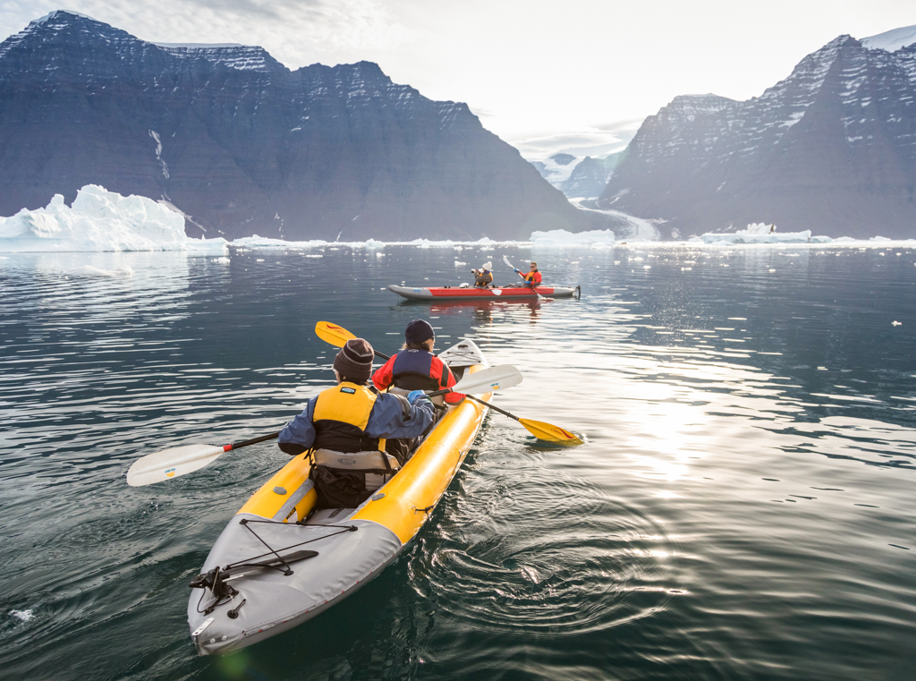 four people kayaking in Antarctica